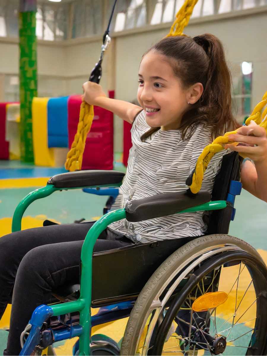 girl-in-wheelchair-playing-with-swing